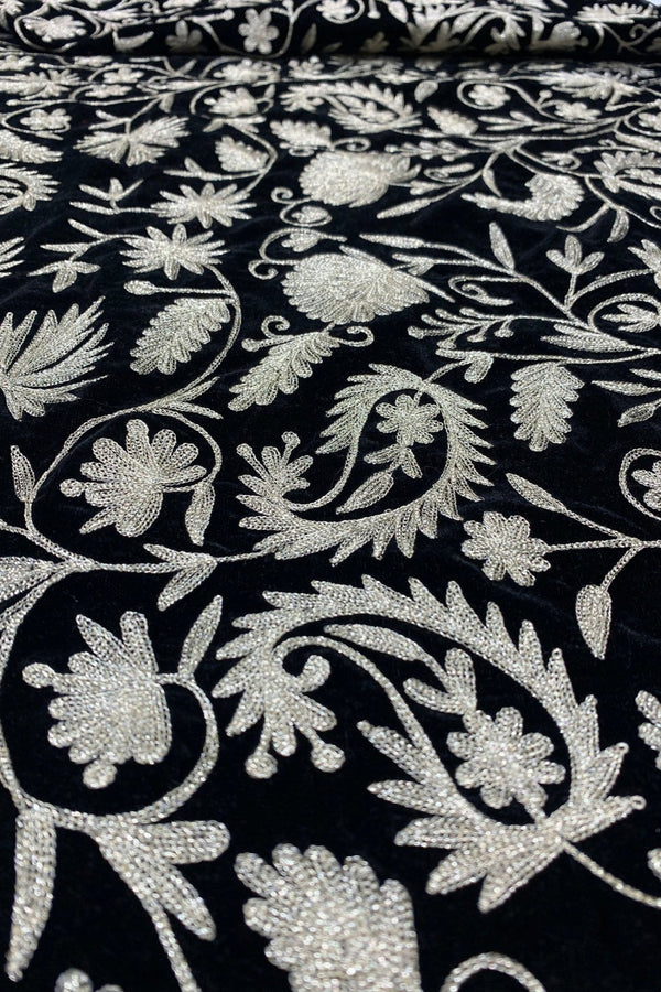 #black Close-up of black fabric with dull gold floral embroidery