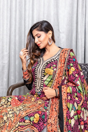 #Black Woman wearing a colorful embroidered traditional outfit with a white curtain background