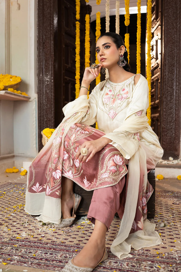 #OmbreCream&Mauve Woman in traditional outfit sitting on a decorative swing with yellow flowers.