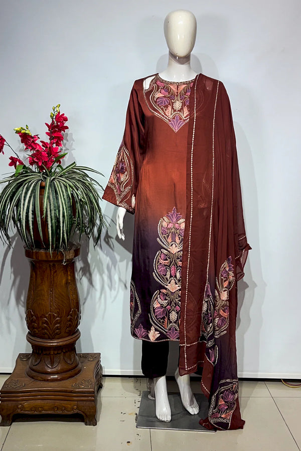 #OmbreWine&Purple Mannequin wearing a brown dress with floral patterns next to a potted plant on a white background