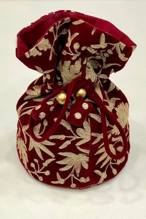 #Red Red fabric pouch with gold embroidery on a white background