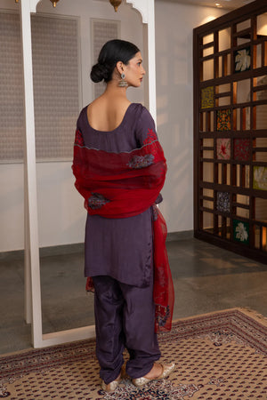 #Mauve - Back view of mauve kurta showing deep scoop back neckline and red embroidered sleeve clusters with crimson dupatta draped over shoulders