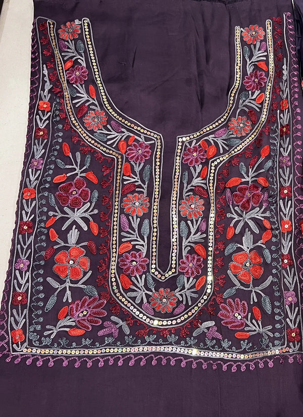 #mauve Two pieces of fabric, one with a floral Aari and sequence work in the center and the other with a border featuring the same style of work.
