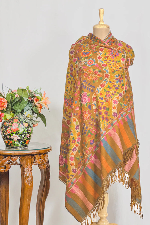 Drape detail of hand Kani mustard Pashmina shawl showing how the cloth falls and holds its structure