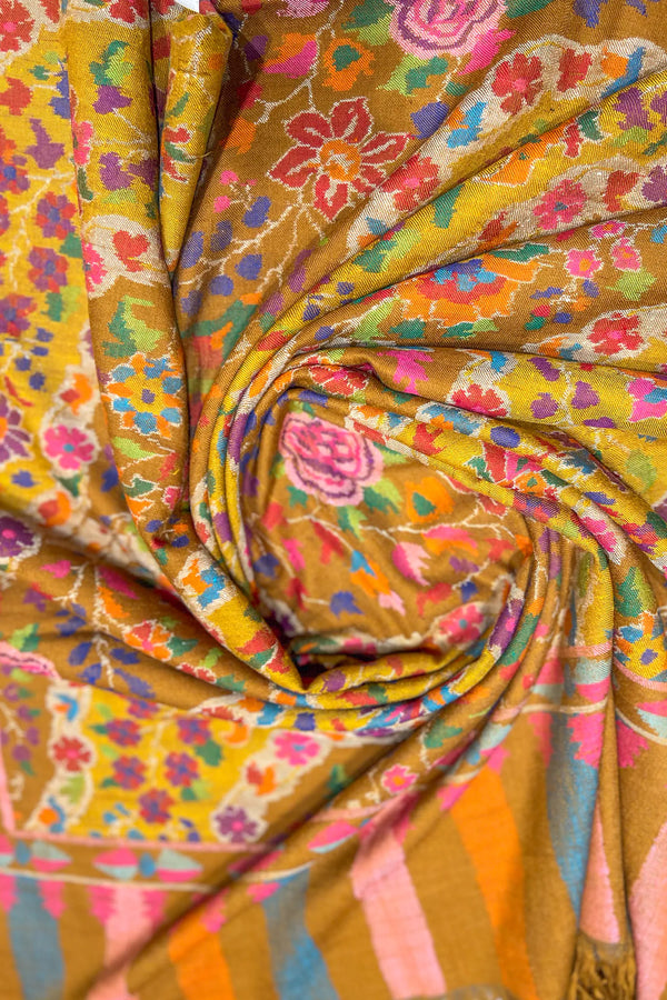 Mustard Kani shawl folded to show layered weave depth and multi-coloured floral arrangement