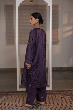 #Mauve - Back view of purple linen satin kurta; plain back with gold tilla cuff border; salwar with scattered floral butis visible.