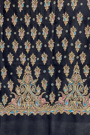 Black fabric with intricate gold and multicolor floral patterns