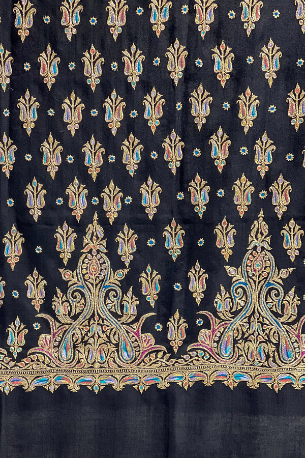 Black fabric with intricate gold and multicolor floral patterns