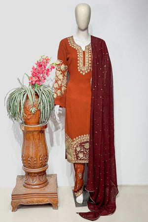 #Rust - Front view of rust viscose georgette kurta with gold tilla neck and sleeve embroidery, maroon dupatta draped to side