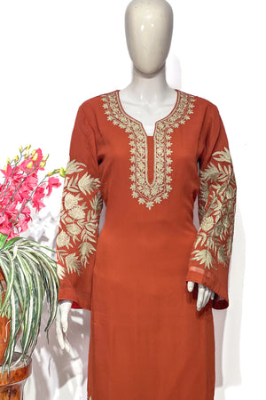 #Rust - Close-up of gold tilla floral and leaf embroidery covering both sleeves and U-shaped neckline panel on rust kurta