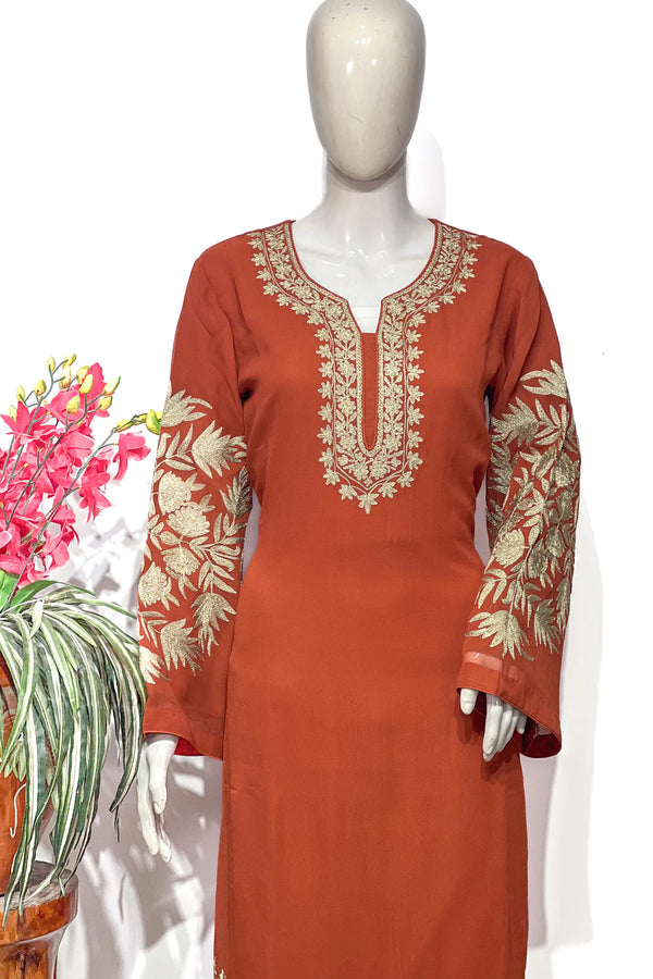 #Rust - Close-up of gold tilla floral and leaf embroidery covering both sleeves and U-shaped neckline panel on rust kurta