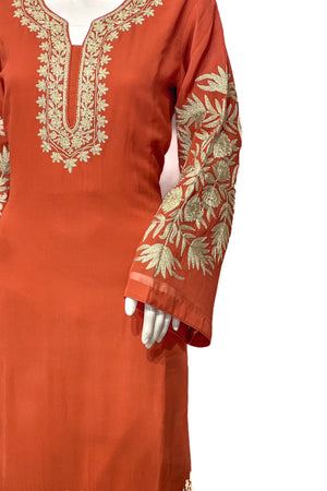 #Rust - Close-up of gold tilla floral and leaf embroidery covering both sleeves and U-shaped neckline panel on rust kurta