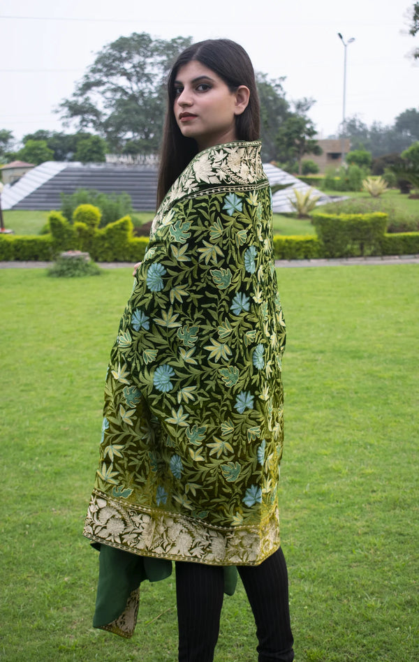 #Green Woman wearing a green embroidered traditional outfit in an outdoor setting