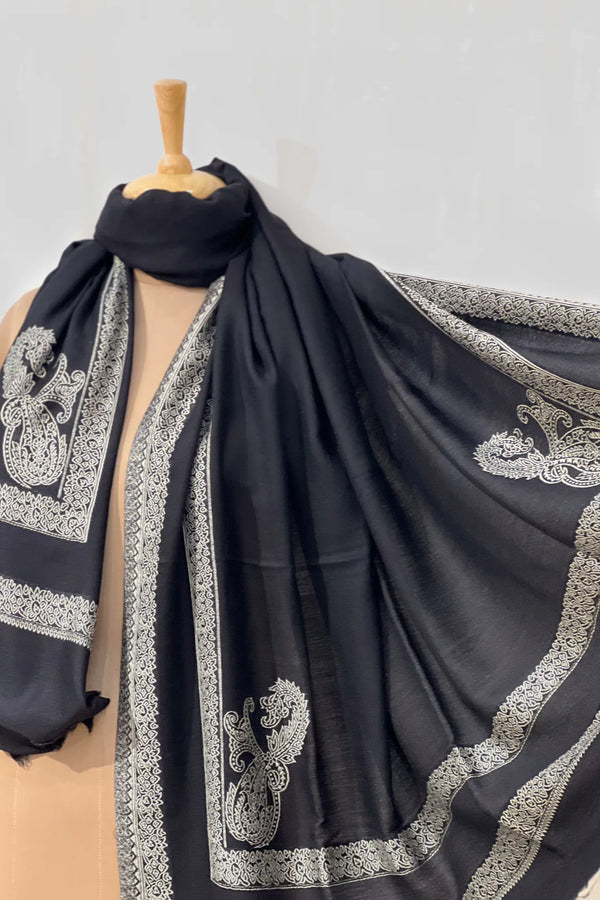 #Black - Black wool shawl draped around the neck and belted at the waist on a mannequin, front-facing view highlighting the central ivory border stripe and corner paisleys