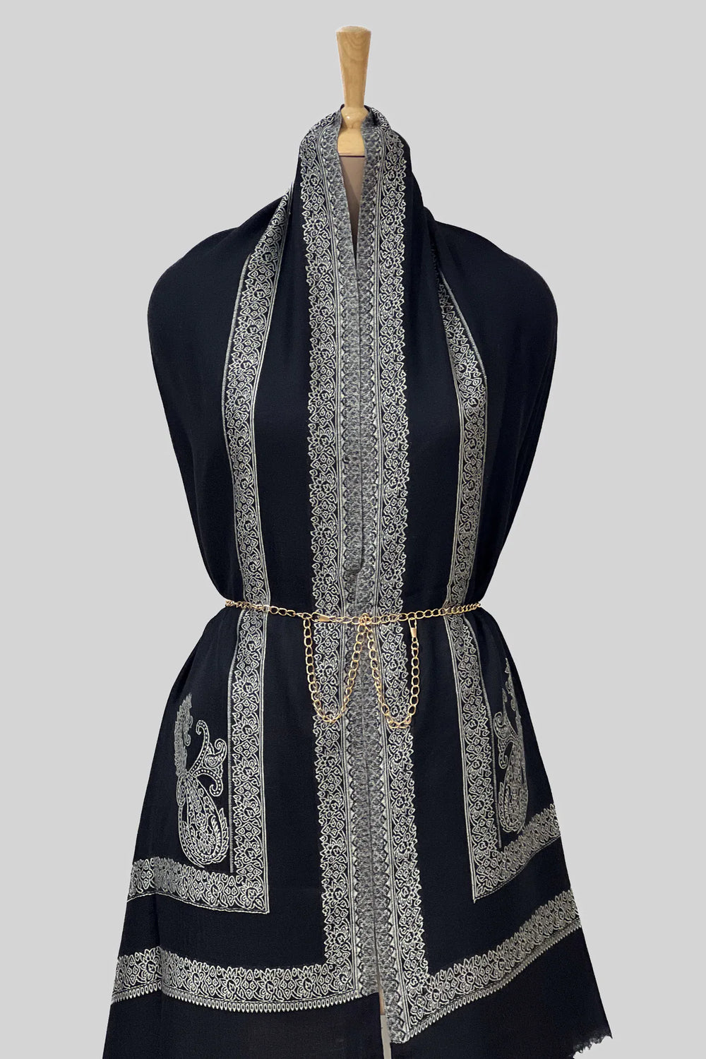 #Black - Black wool shawl with ivory woven paisley border draped over a mannequin, showing drape volume and corner boteh detail