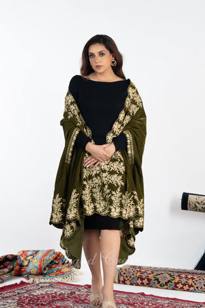 #OliveGreen Woman wearing a black outfit with an olive green shawl featuring gold embroidery on a white background.