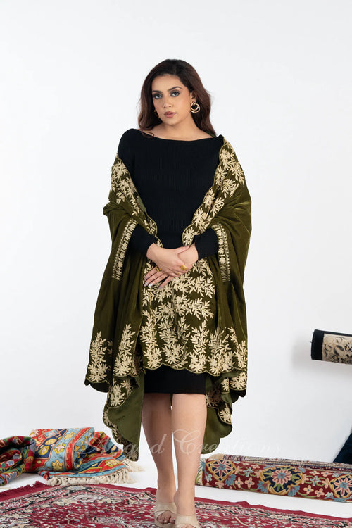 #OliveGreen Woman wearing a black outfit with an olive green shawl featuring gold embroidery on a white background.