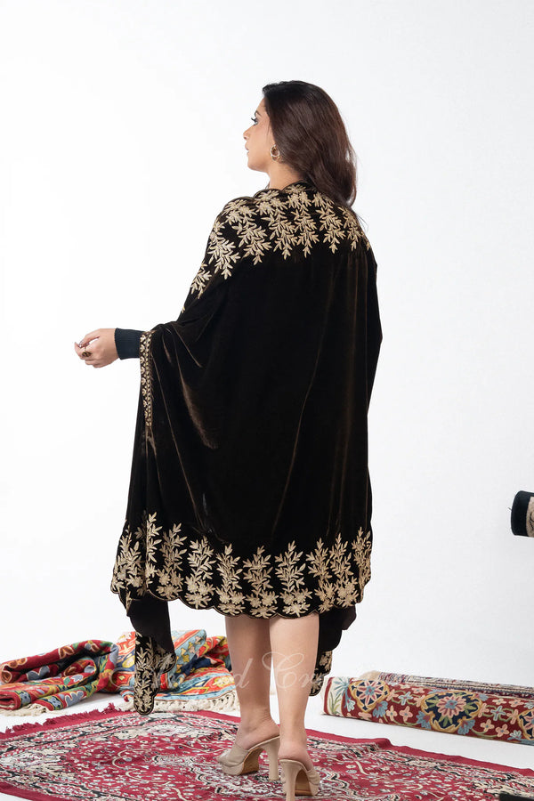 #DarkBrown Woman wearing a brown outfit with gold embroidery on a white background