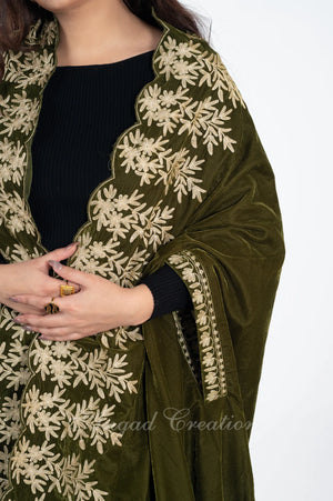 #OliveGreen embroidered shawl over a black top on a white background