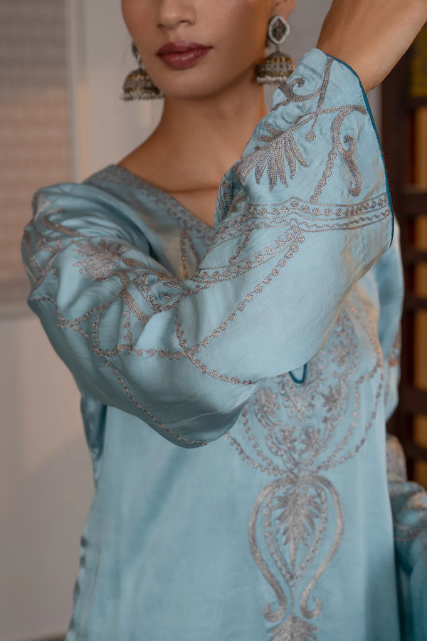 #OmbreSky&PeacockBlue - Close-up of flared bell sleeve on sky-blue ombre kurta showing silver zari leaf spray and swag chain embroidery