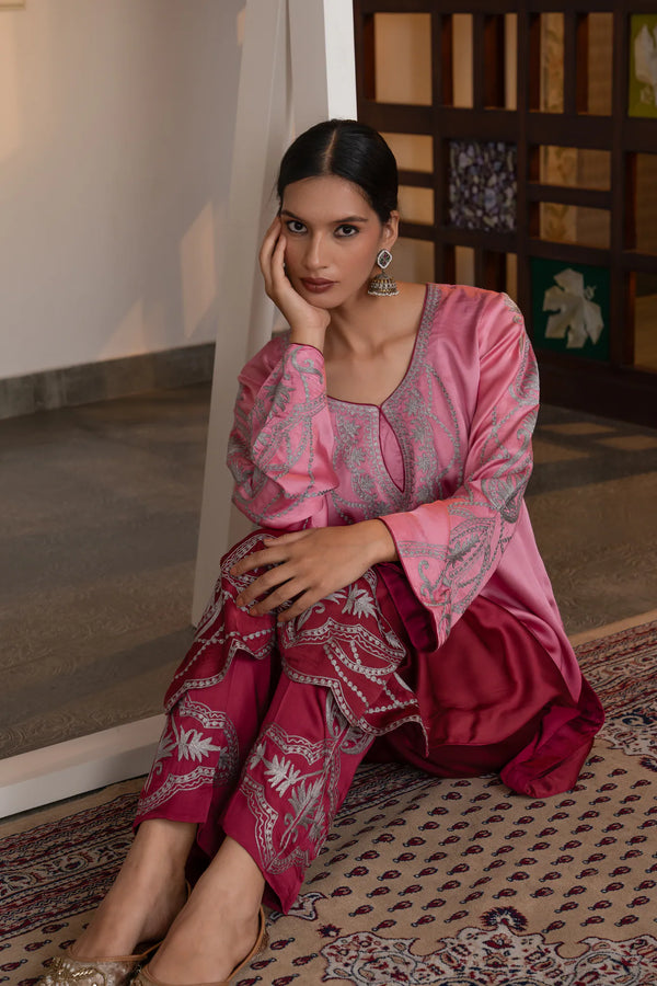 #OmbreRosePink&DeepBerry - Seated front view showing full wine-mauve embroidered suit set with silver zari on kurta bodice, sleeves, and heavily worked trousers