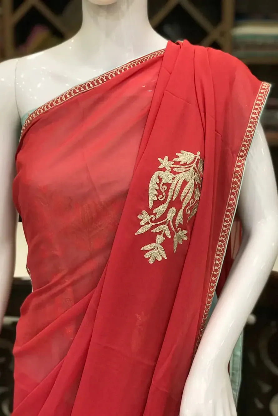 #Pink saree with gold patterns on a mannequin in a store setting