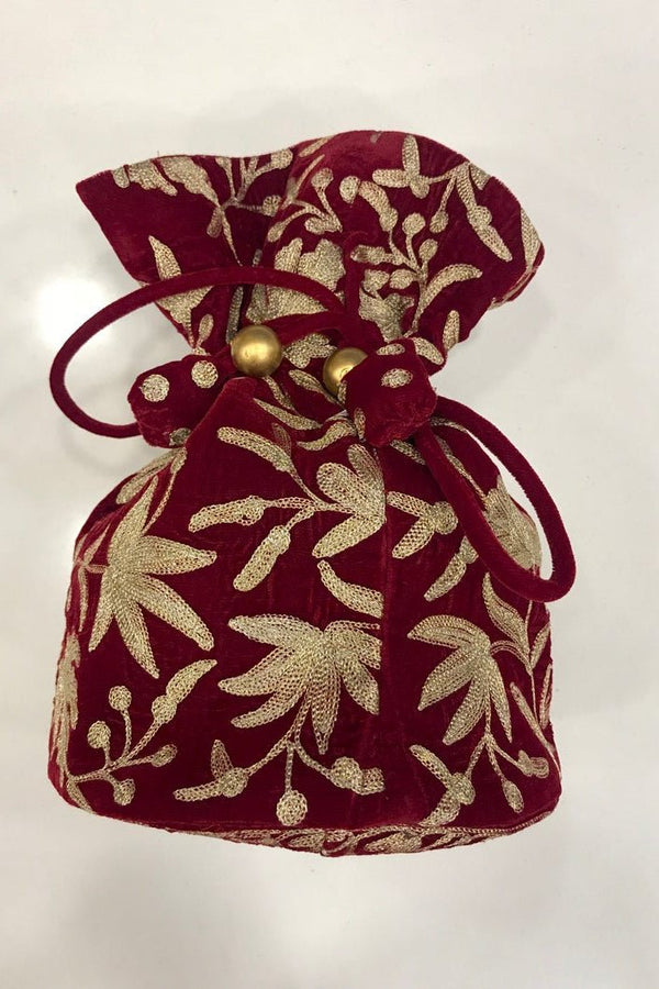 #Red Decorative red drawstring bag with gold leaf pattern on a white background
