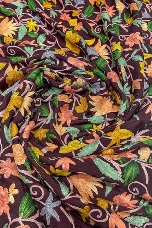 Floral patterned fabric with colorful flowers on a dark background