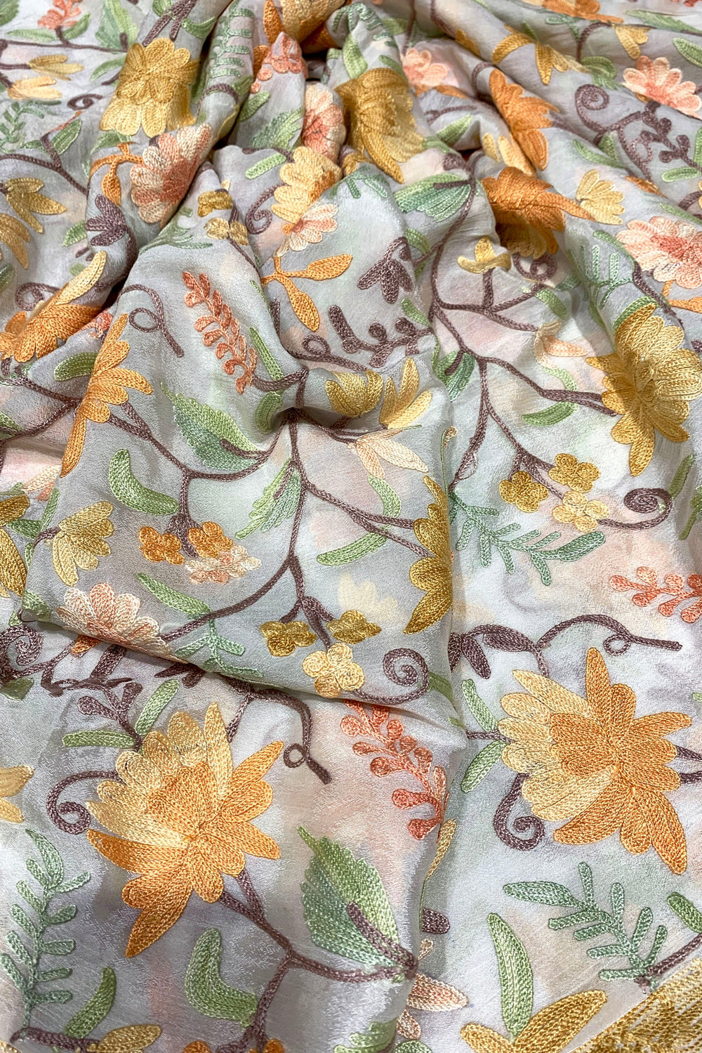 Embroidered fabric with floral patterns on a light background