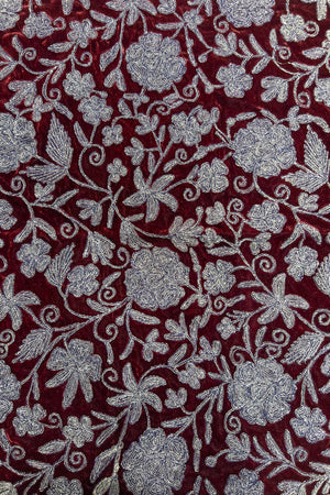 Floral patterned fabric with copper flowers on a red background