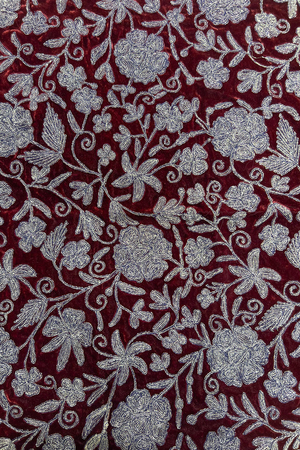 Floral patterned fabric with copper flowers on a red background
