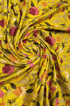 Yellow fabric with floral embroidery and patterns