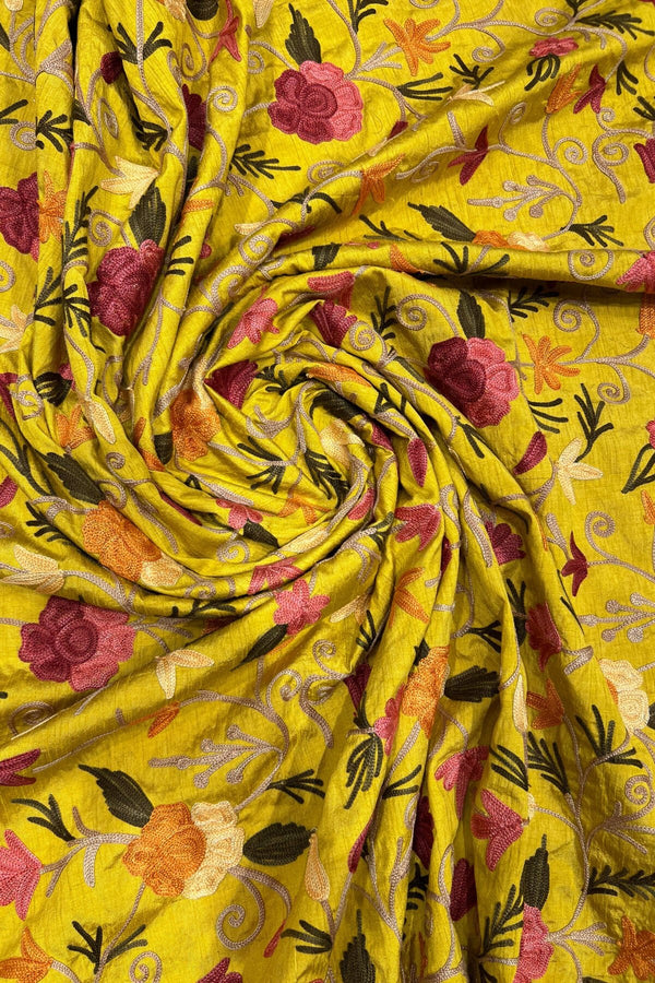 Yellow fabric with floral embroidery and patterns