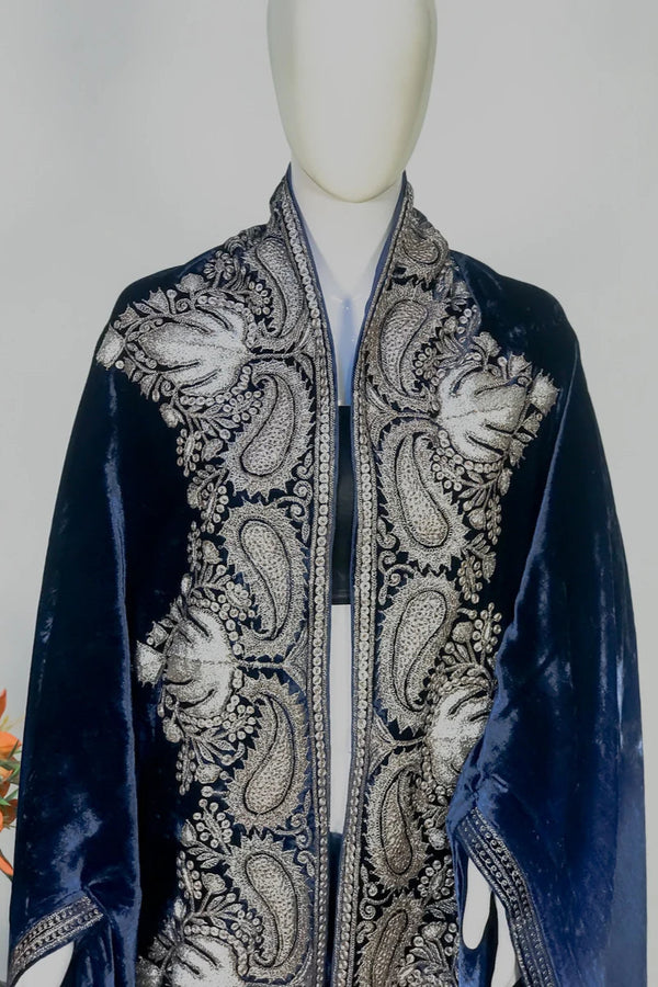 Navy blue velvet cape with intricate silver paisley patterns on a mannequin against a gray background