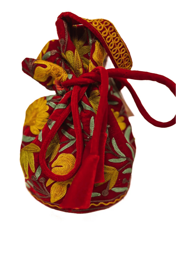 Decorative fabric pouch with red drawstring on a white background