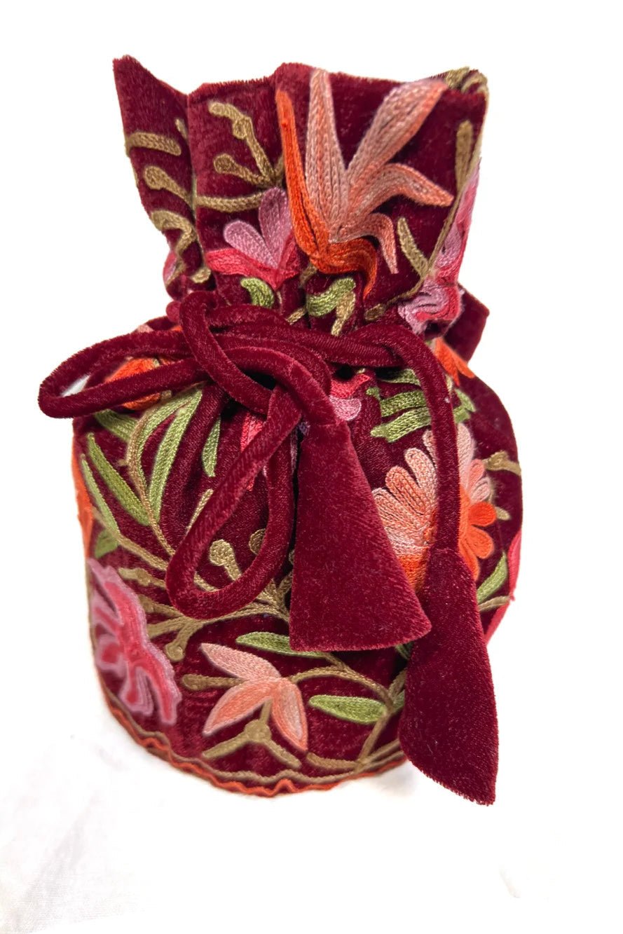 Decorative bag with floral embroidery on a white background