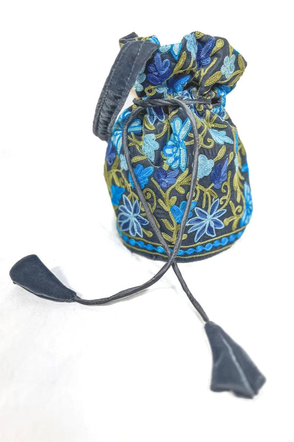 Decorative drawstring bag with blue floral patterns on a white background