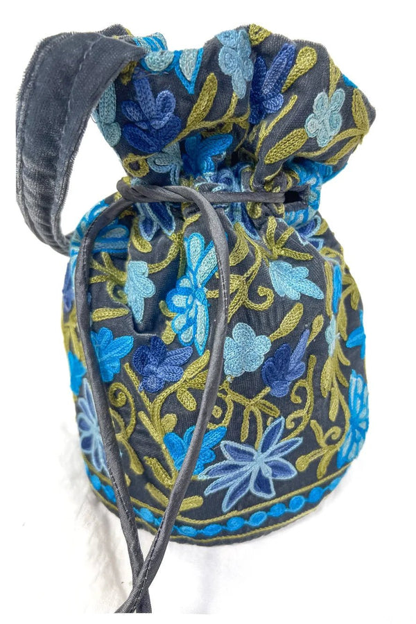 Embroidered fabric bag with blue floral pattern on a white background