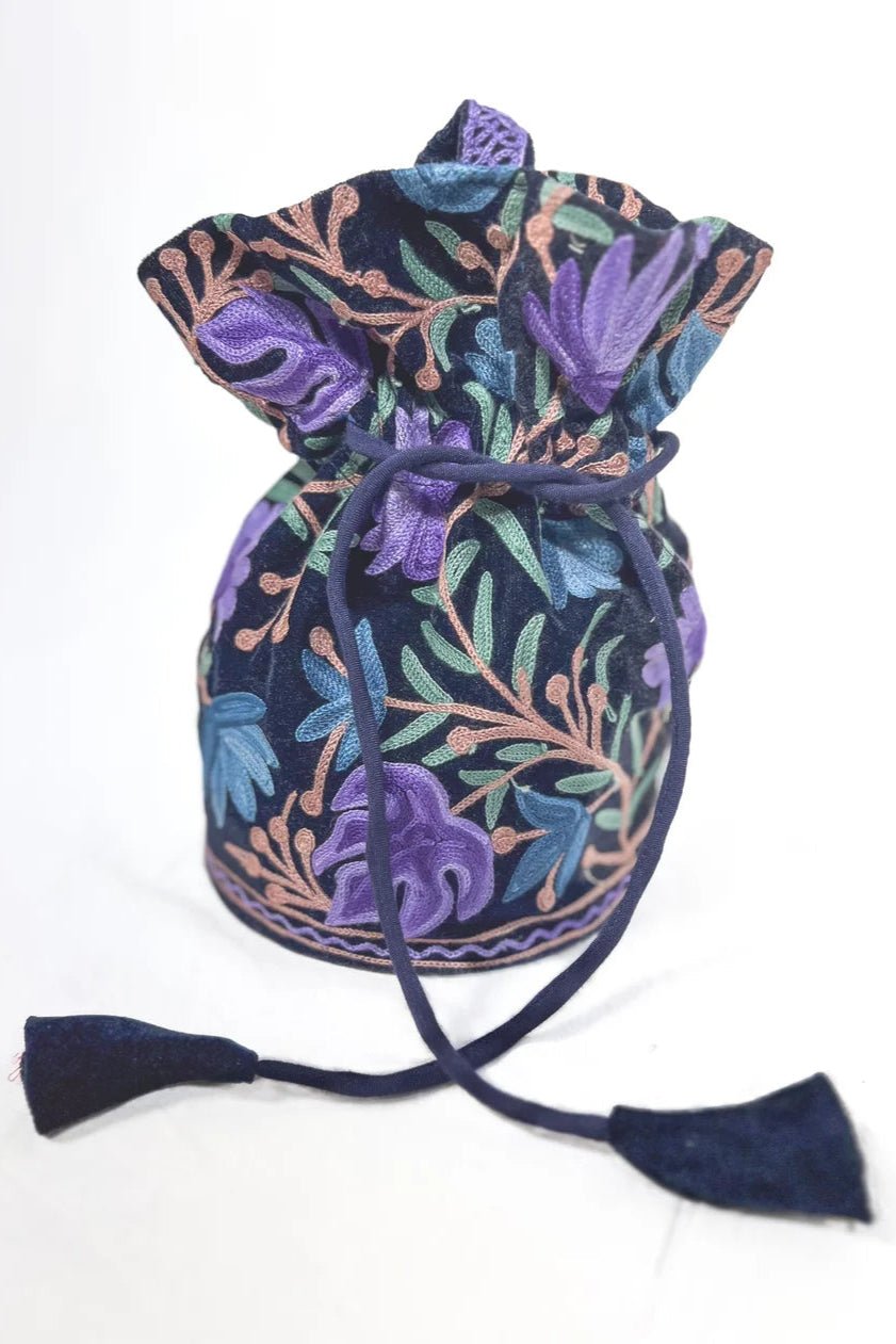 Decorative drawstring bag with floral patterns on a white background