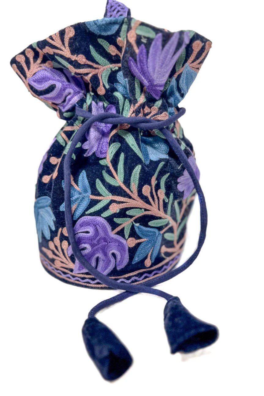 Decorative drawstring bag with floral patterns on a white background