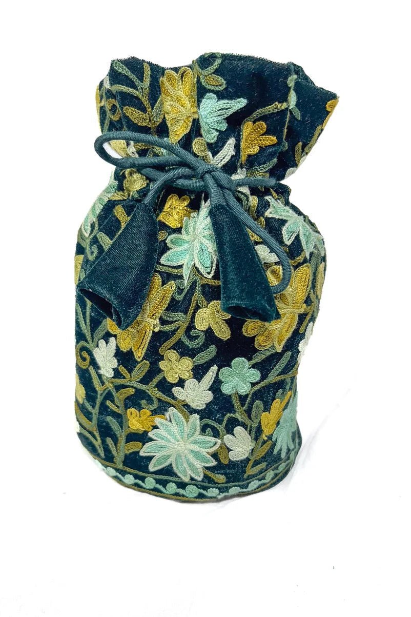 Embroidered fabric pouch with floral patterns on a white background