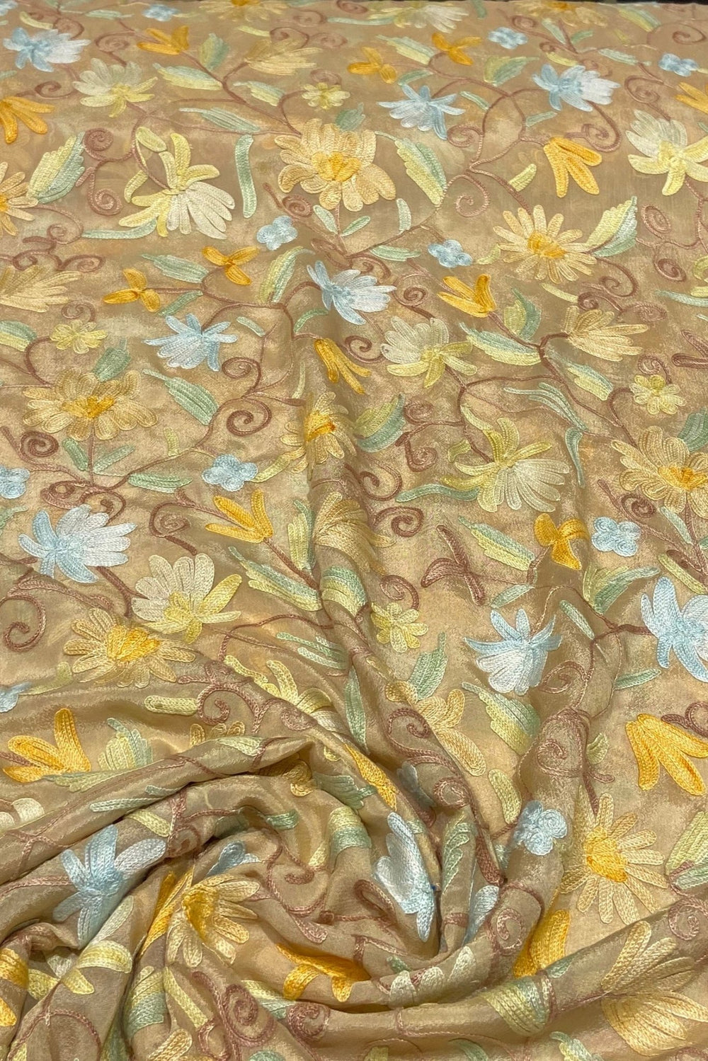 Textile with floral embroidery on a beige background