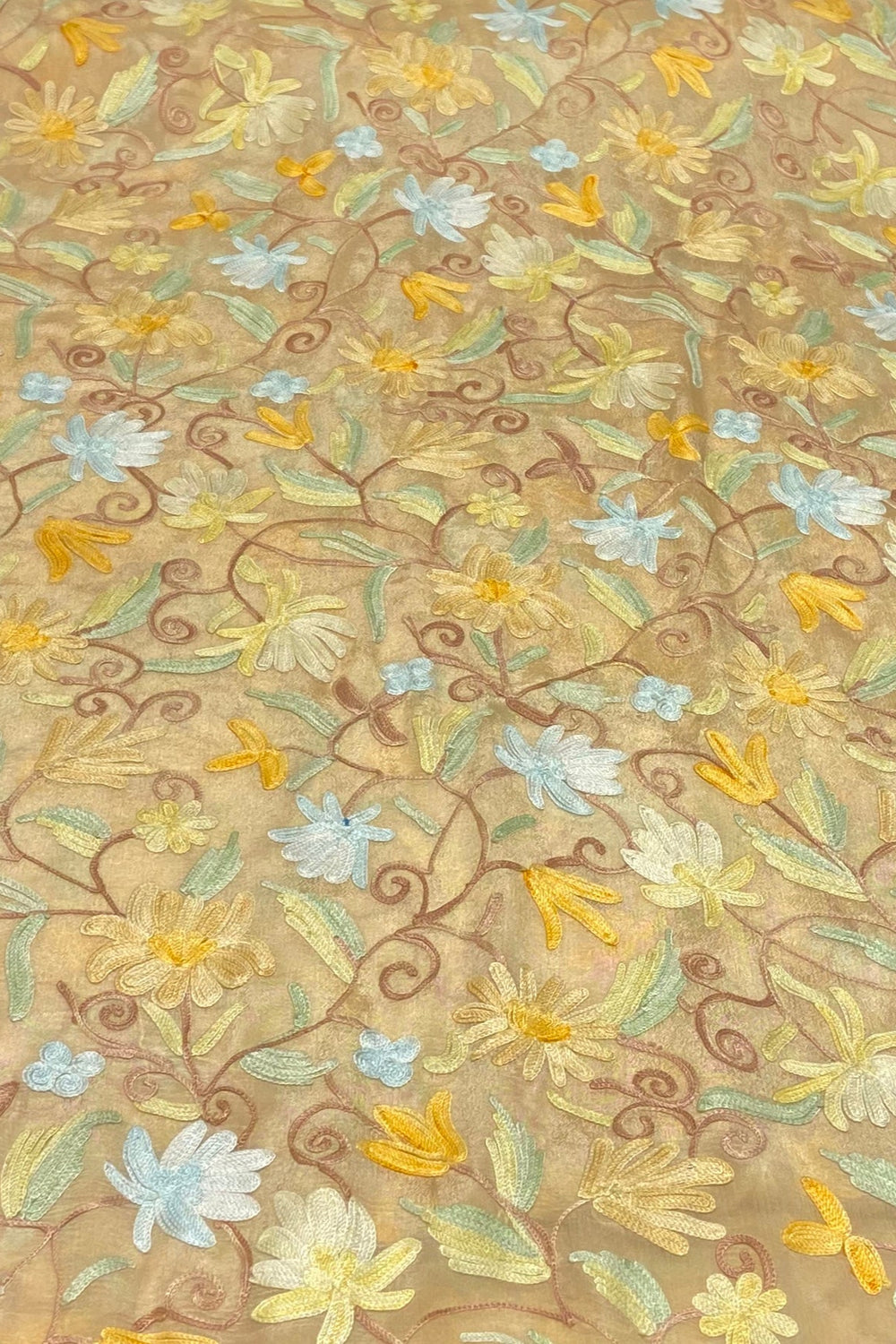 Textile with floral embroidery on a beige background