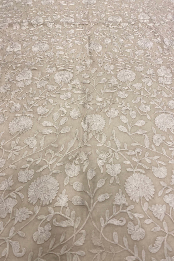 Textured fabric with floral pattern on a off-white background