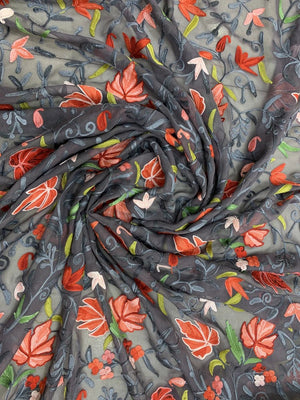 Roll of fabric with floral pattern on a gray background