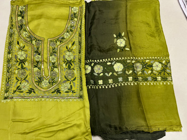 #Lime Two pieces of fabric, one with a floral Aari and sequence work in the center and the other with a border featuring the same style of work.