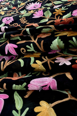 Close-up of floral embroidery on black fabric