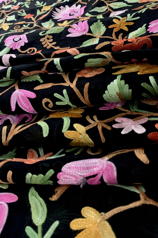 Close-up of floral embroidery on black fabric