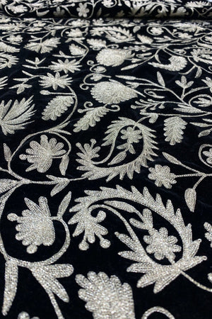#black Close-up of black fabric with dull gold floral embroidery
