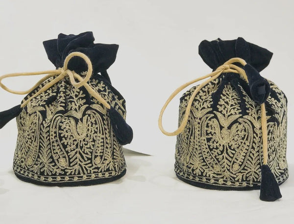 Two black and gold embroidered bags on a white background